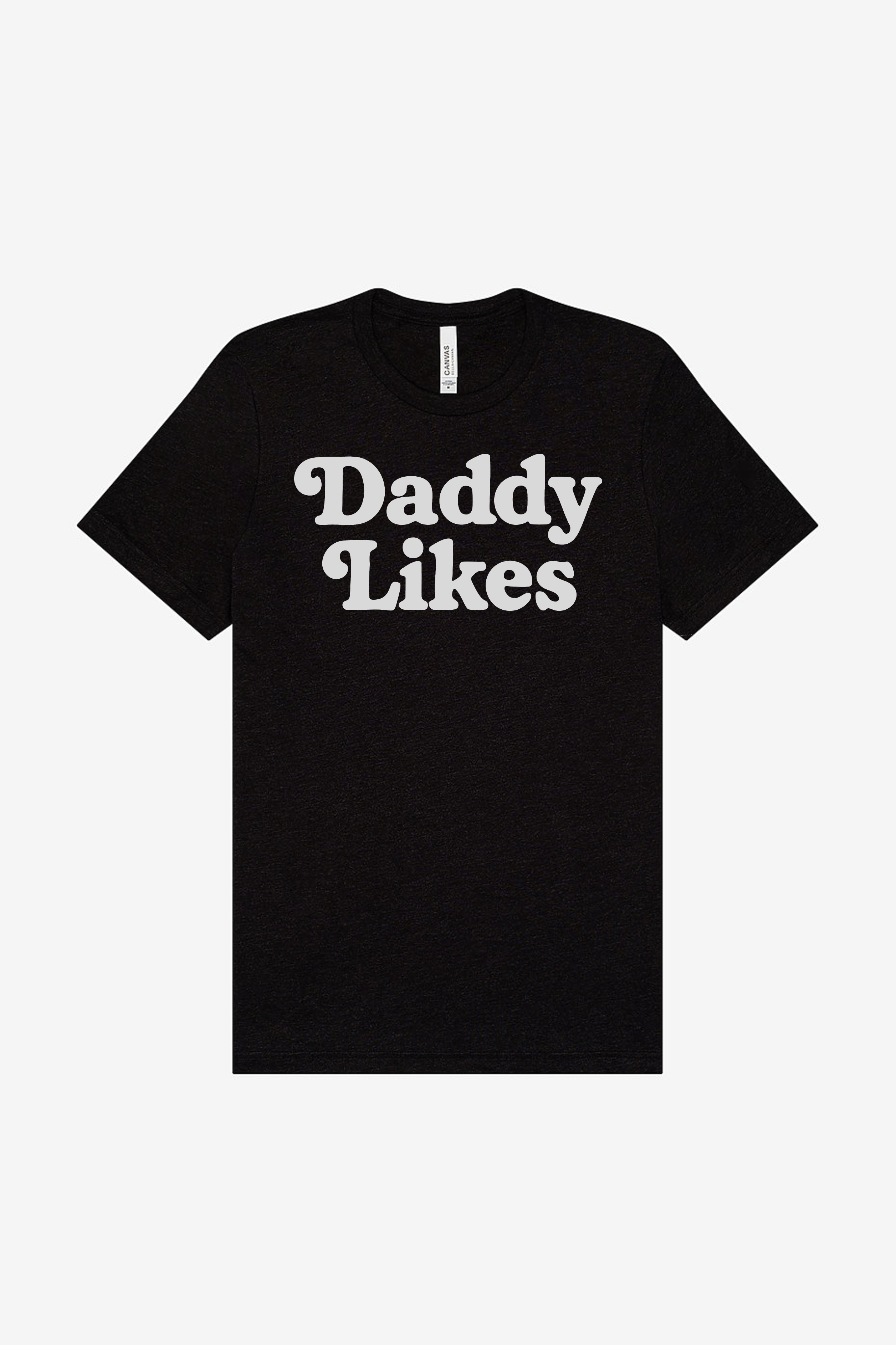 Black t-shirt with 'Daddy Likes' text on a white background